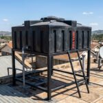 Loft tank mounted on a rooftop stand at a home in Kenya