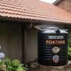 Rainwater harvesting setup with gutter and storage tank at a Kenyan home