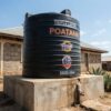 5000 litre Poa cylindrical water tank on a concrete base at a Kenyan home