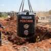 Underground BELL water tank being lowered into an excavated pit in Kenya