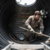 Person cleaning the interior of a water tank in Kenya
