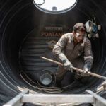 Person cleaning the interior of a water tank in Kenya