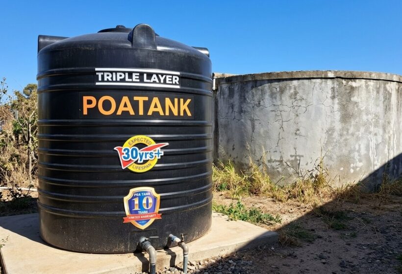 Plastic vs concrete water tanks side by side on a sunny Kenyan compound